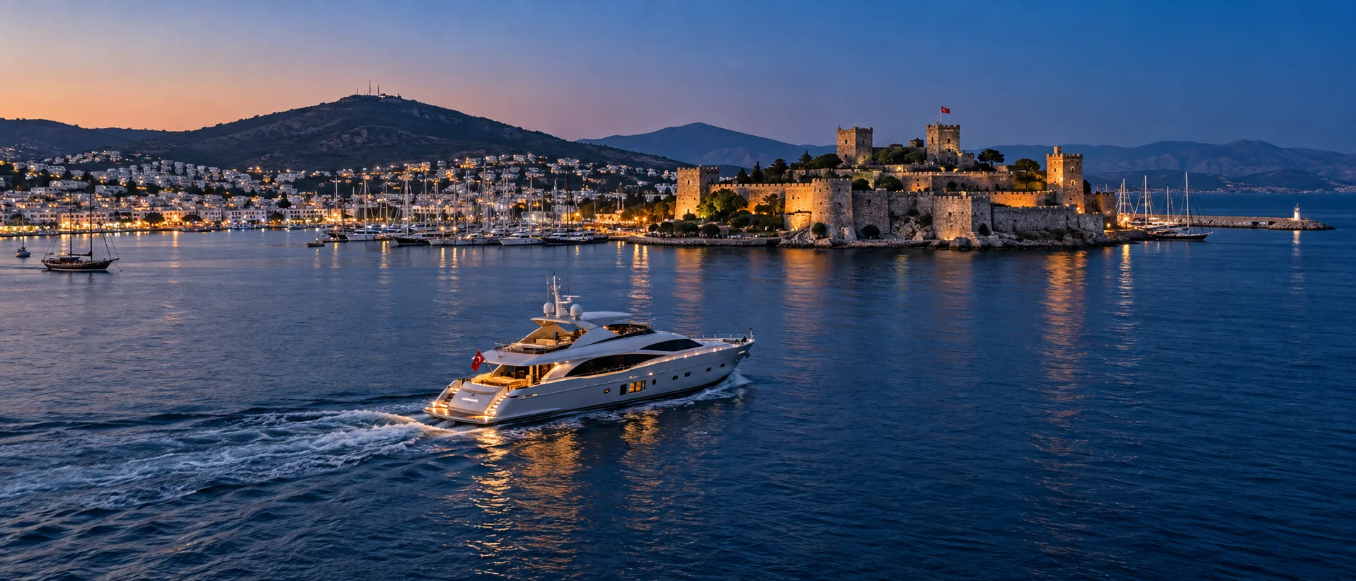 Motor yacht passing Bodrum Castle at blue hour