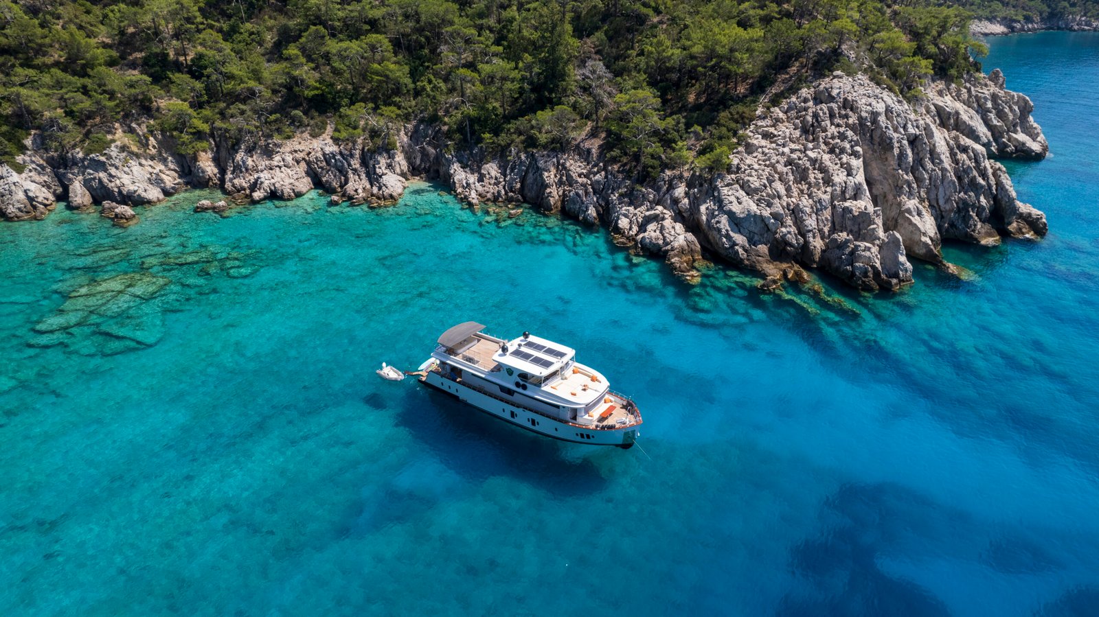SS2605 deluxe trawler at anchor in a Göcek cove near Fethiye