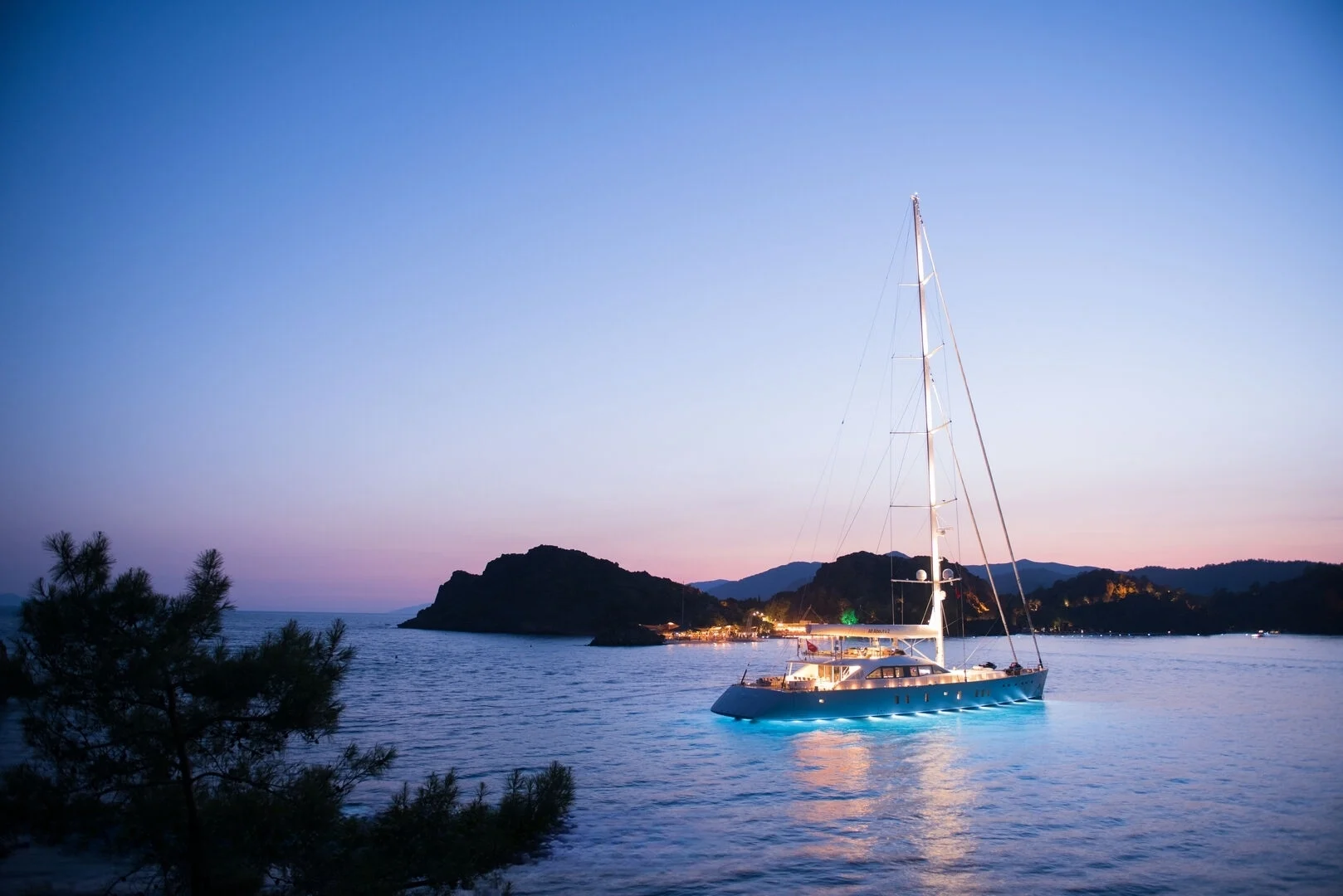 50m motor sailer at anchor at sunset near Bodrum — crewed superyacht charter AA5019