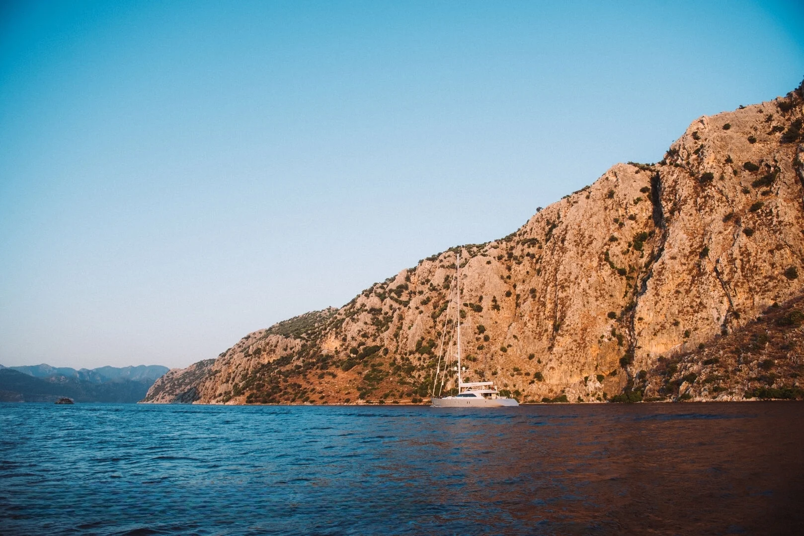 50m motor sailer anchored beneath a cliff on the Turkish Riviera — AA5019