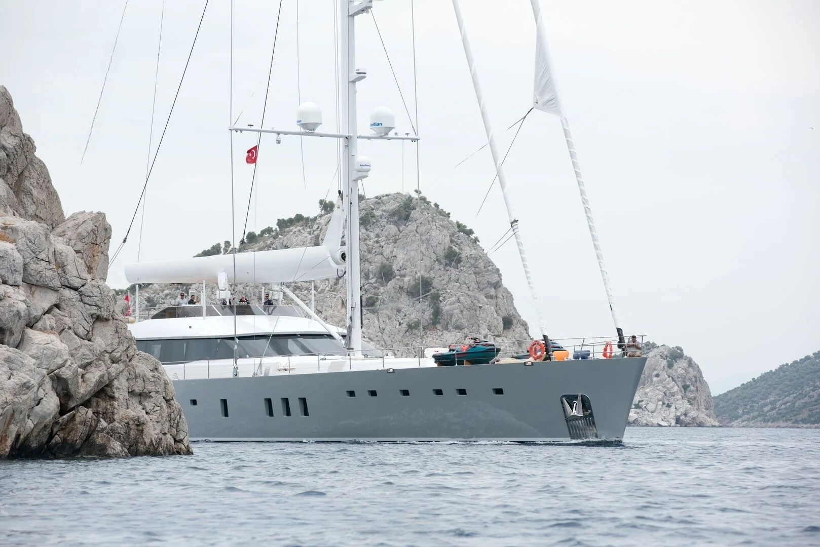50m motor sailer anchored against rock cliffs, Turkish Riviera charter — AA5019
