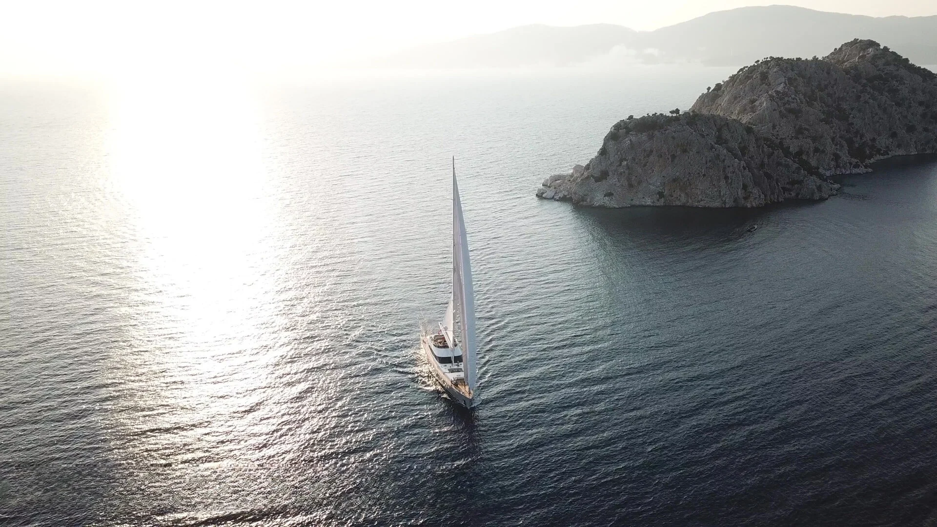 50m motor sailer under sail into the light, Turkish Riviera charter — AA5019