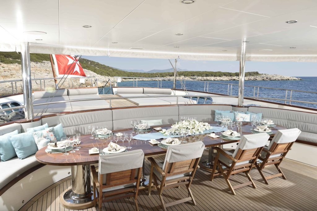 Aft deck dining table laid for twelve aboard a 55m superyacht in Turkey