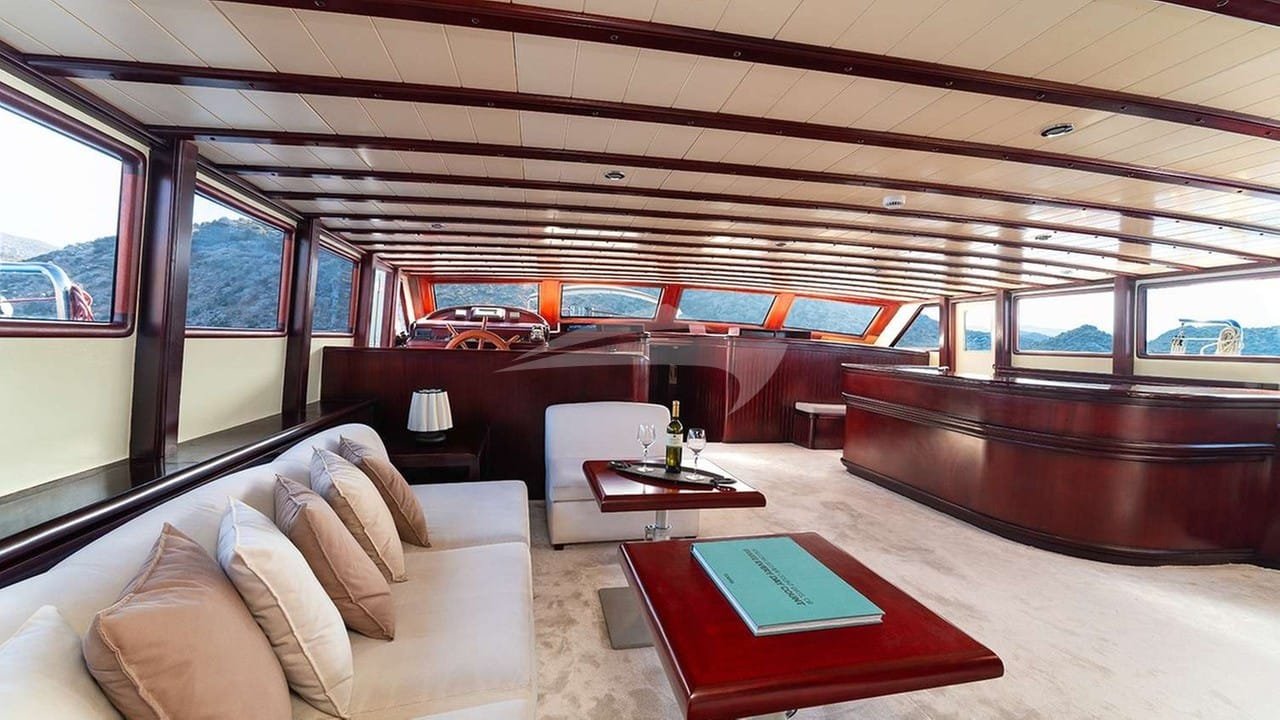 Saloon lounge seating of a crewed motor yacht charter in Gocek with sea views on both sides