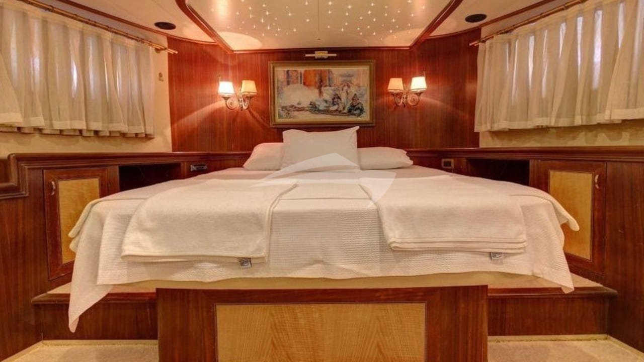 Master cabin with mahogany panelling aboard a crewed yacht charter in Bodrum