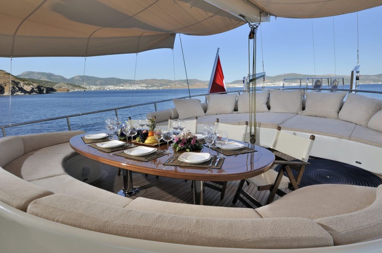 Aft deck dining with a circular banquette aboard a deluxe gulet charter in Turkey