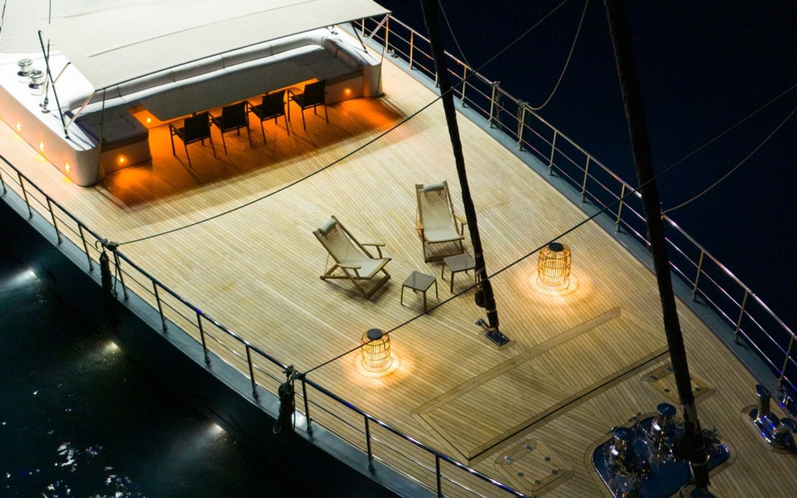 Foredeck dining table under deck lighting at night on a luxury sailing yacht charter in Gocek
