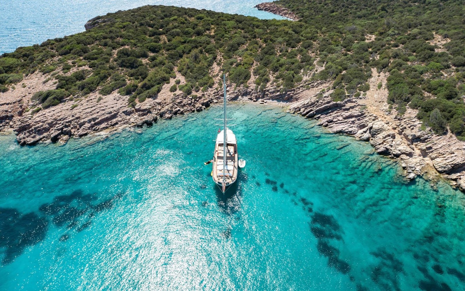 Aerial bow view of a 30m deluxe gulet charter Bodrum anchored in a sheltered cove — ED3011