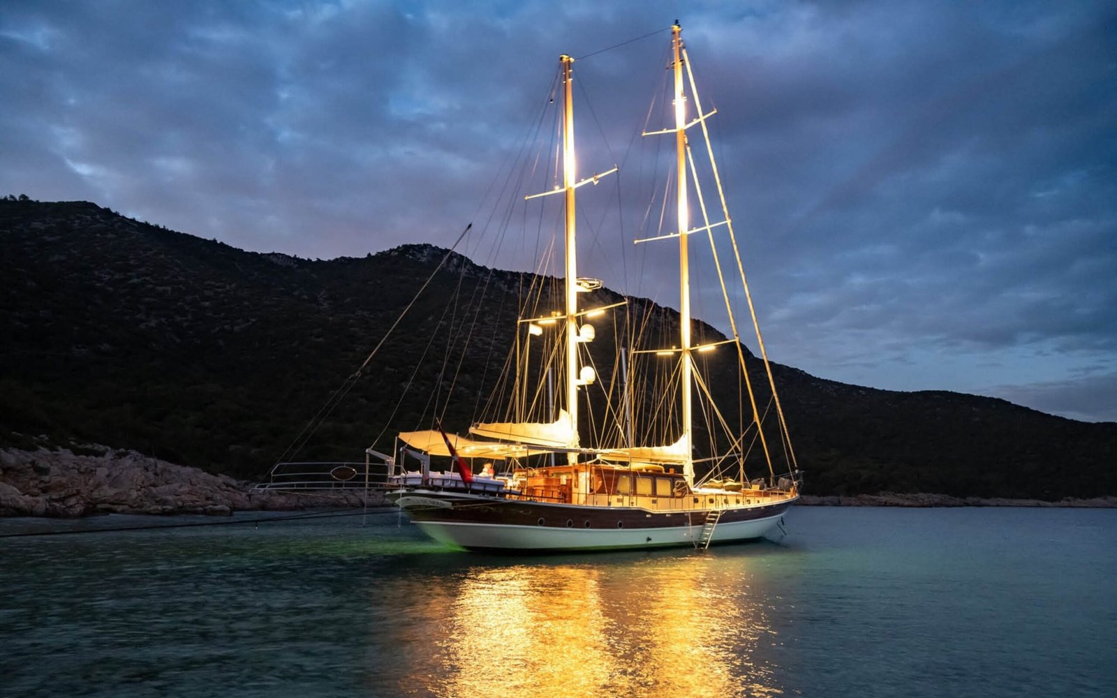 30m deluxe gulet lit at anchor at sunset off Bodrum — luxury gulet charter ED3011