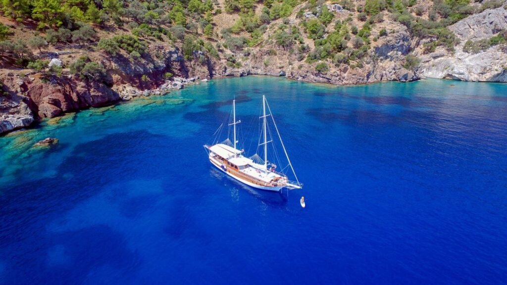 Gulet charter Marmaris: a 28m wooden ketch at anchor in a deep blue Aegean bay