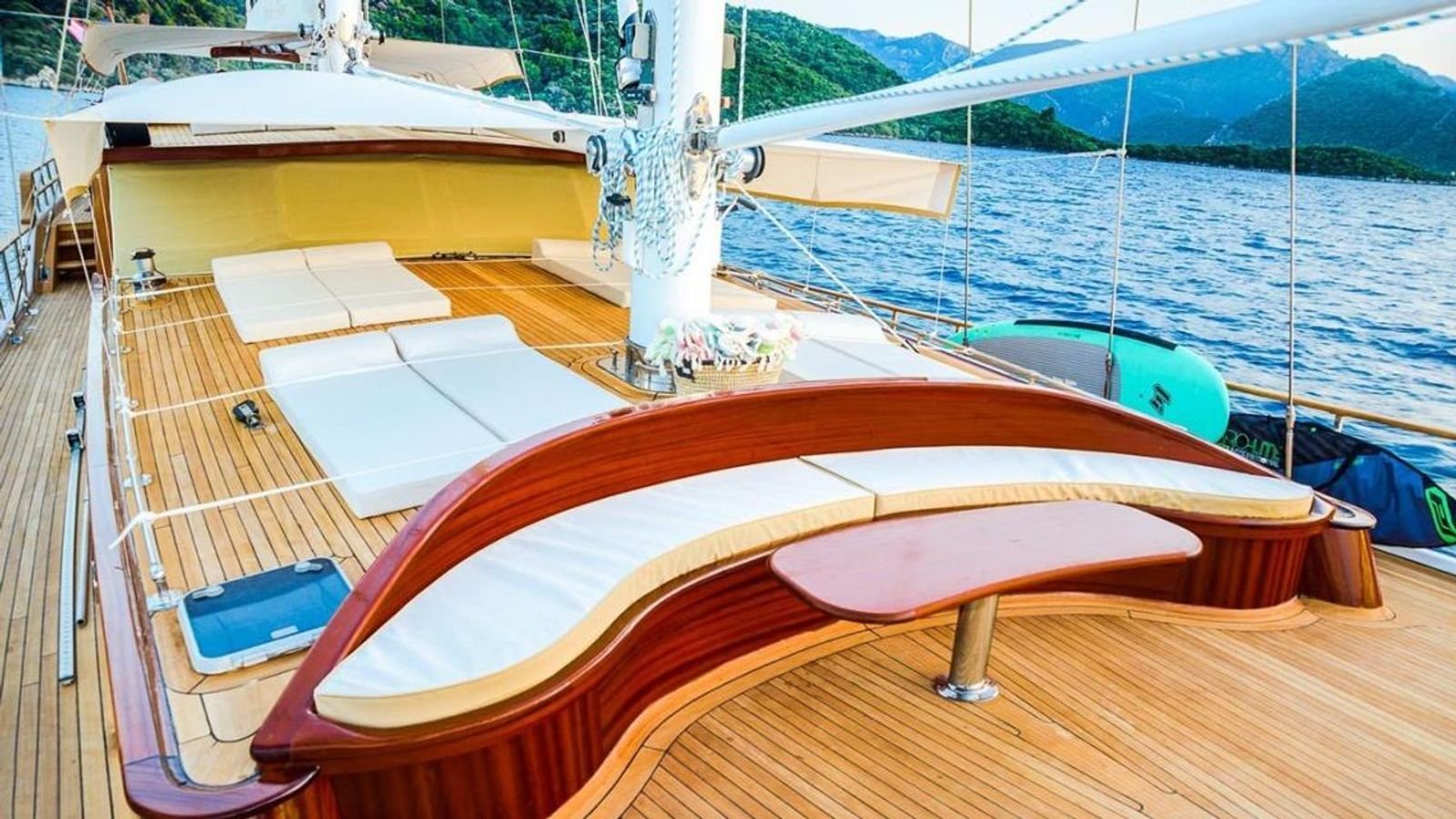 Foredeck sunpads behind a mahogany coaming on a traditional gulet charter Bodrum yacht