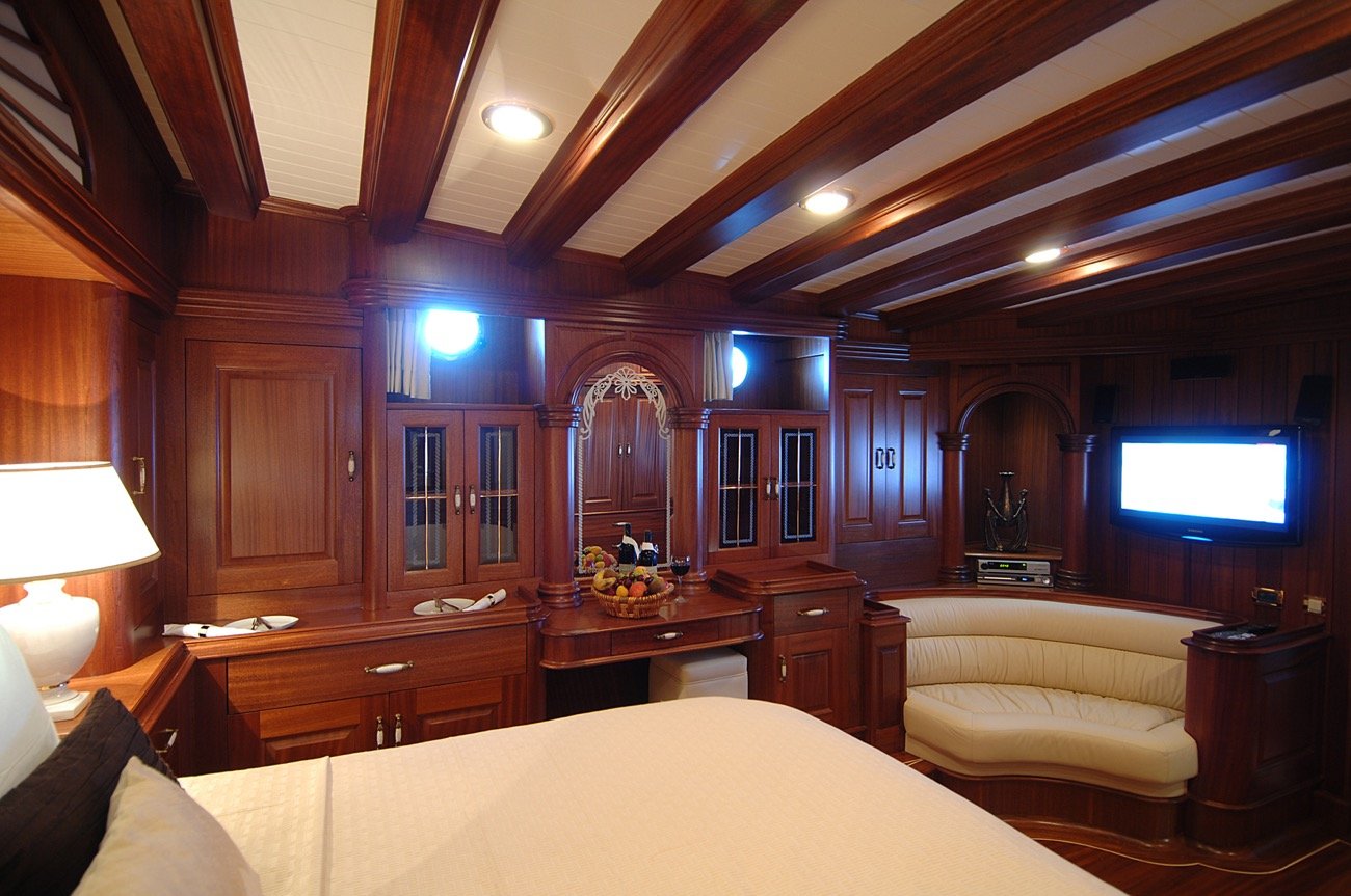 Master cabin with vanity and lounge seating aboard a 43m motor sailer charter — MN4308
