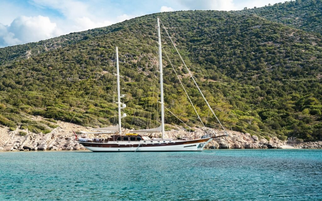 30m deluxe gulet at anchor beside a pine cove near Bodrum — Aquinox ED3011