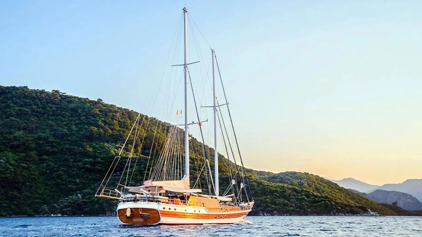 A traditional gulet charter Bodrum vessel at anchor at sunset