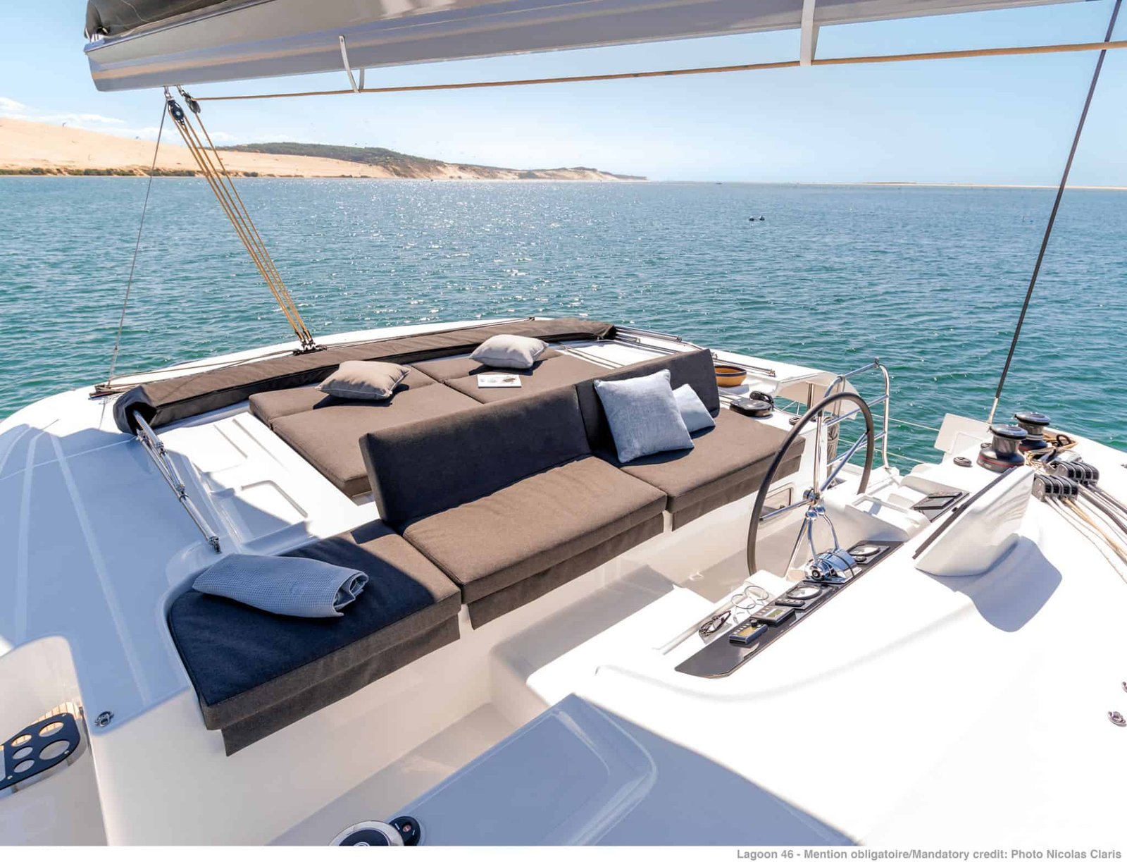 Flybridge sun deck of a Lagoon 46 catamaran charter in Gocek with sunpads beside the helm