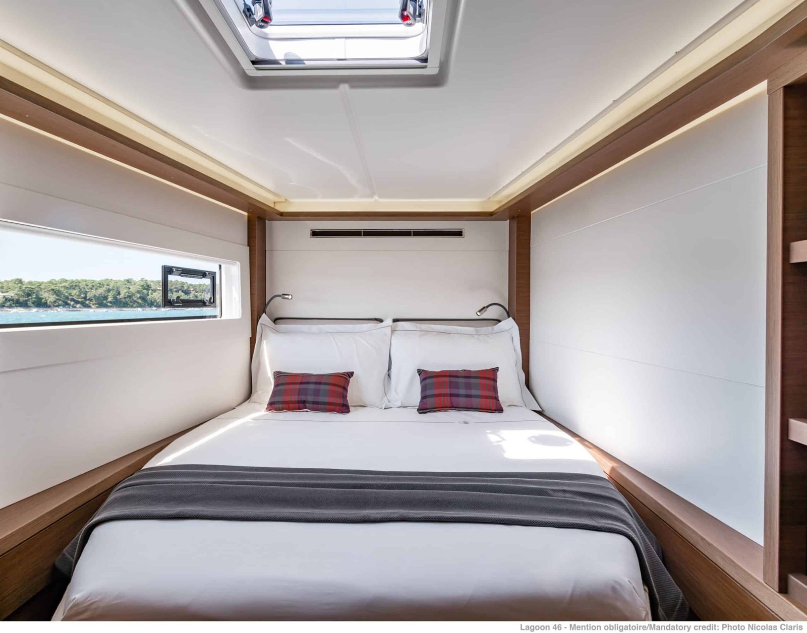 Guest double cabin aboard a Lagoon 46 catamaran charter in Gocek with a long hull window and reading lights