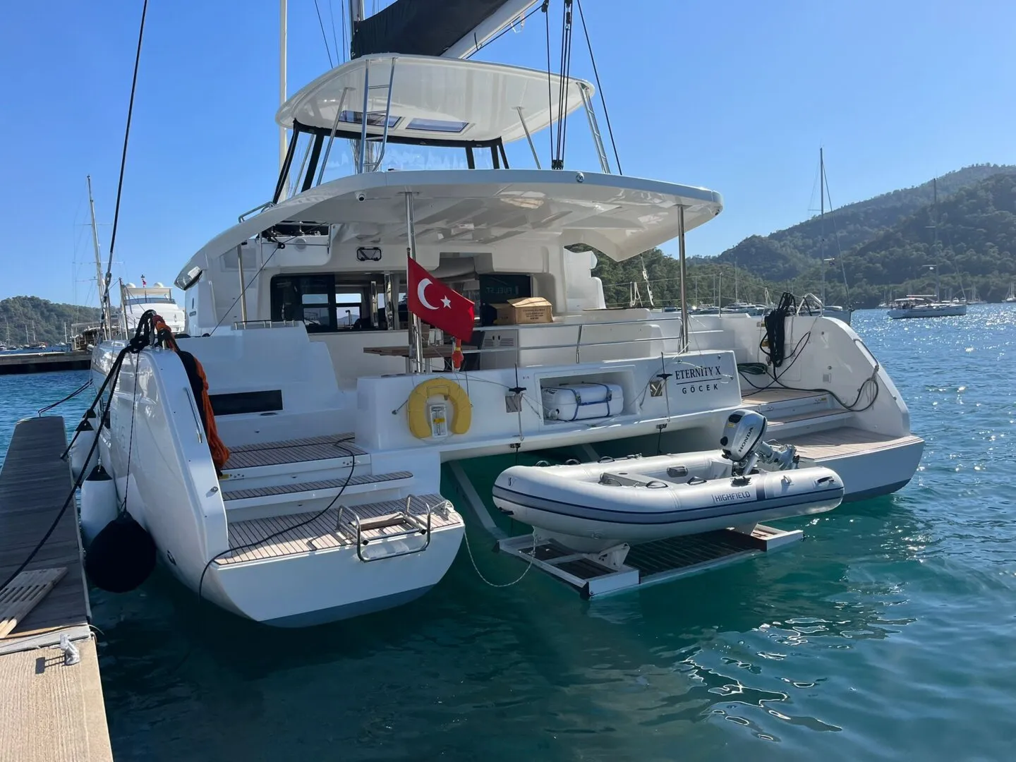 The actual Lagoon 46 catamaran charter Gocek lying stern-to at Marinturk Village Port with her tender alongside