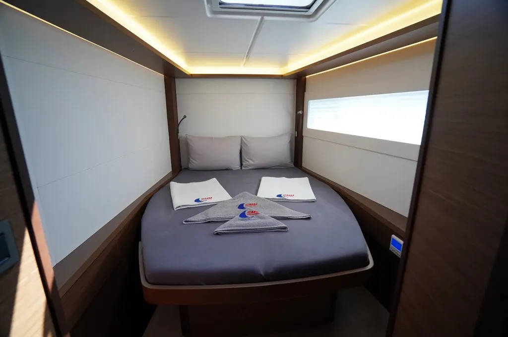 Double cabin of a Lagoon 46 catamaran charter in Marmaris with a hull window at pillow height