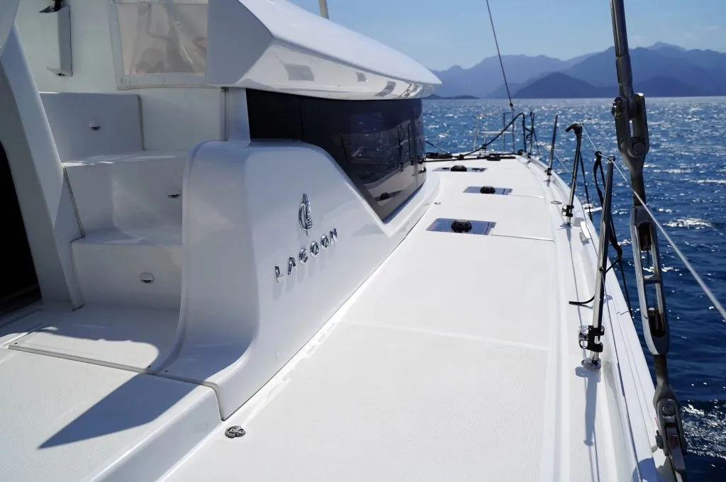 Side deck and coachroof of a Lagoon 46 catamaran charter in Marmaris, builder name moulded into the hull