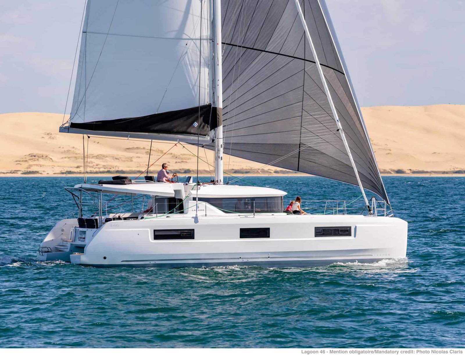 Lagoon 46 charter catamaran sailing beam-on under full main and self-tacking jib