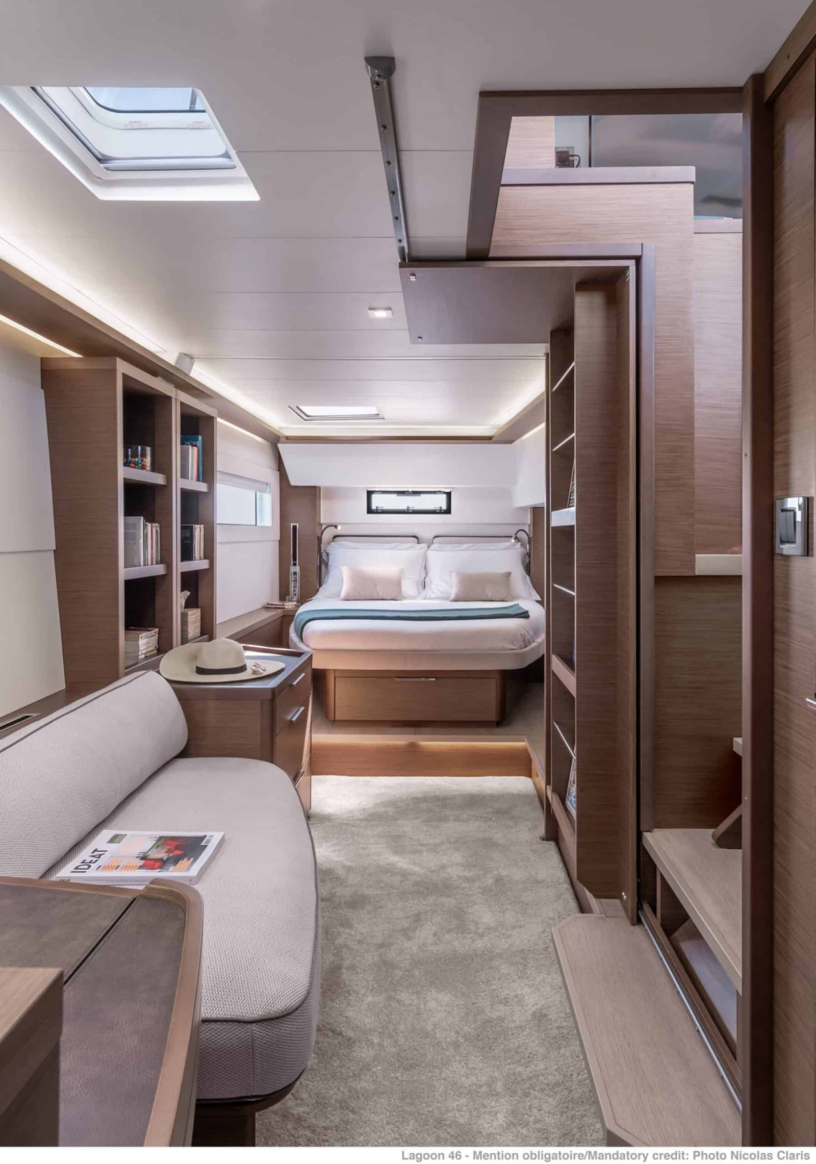 Owner cabin of a Lagoon 46 charter catamaran with an island berth, overhead hatch and hull windows