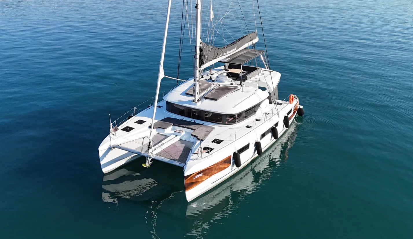 Lagoon 51 catamaran charter Fethiye photographed bow-on from the air at anchor in a sheltered bay