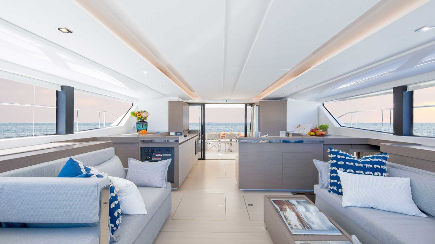 Air-conditioned saloon lounge aboard a Leopard 46 power catamaran charter in Fethiye with panoramic glazing on three sides