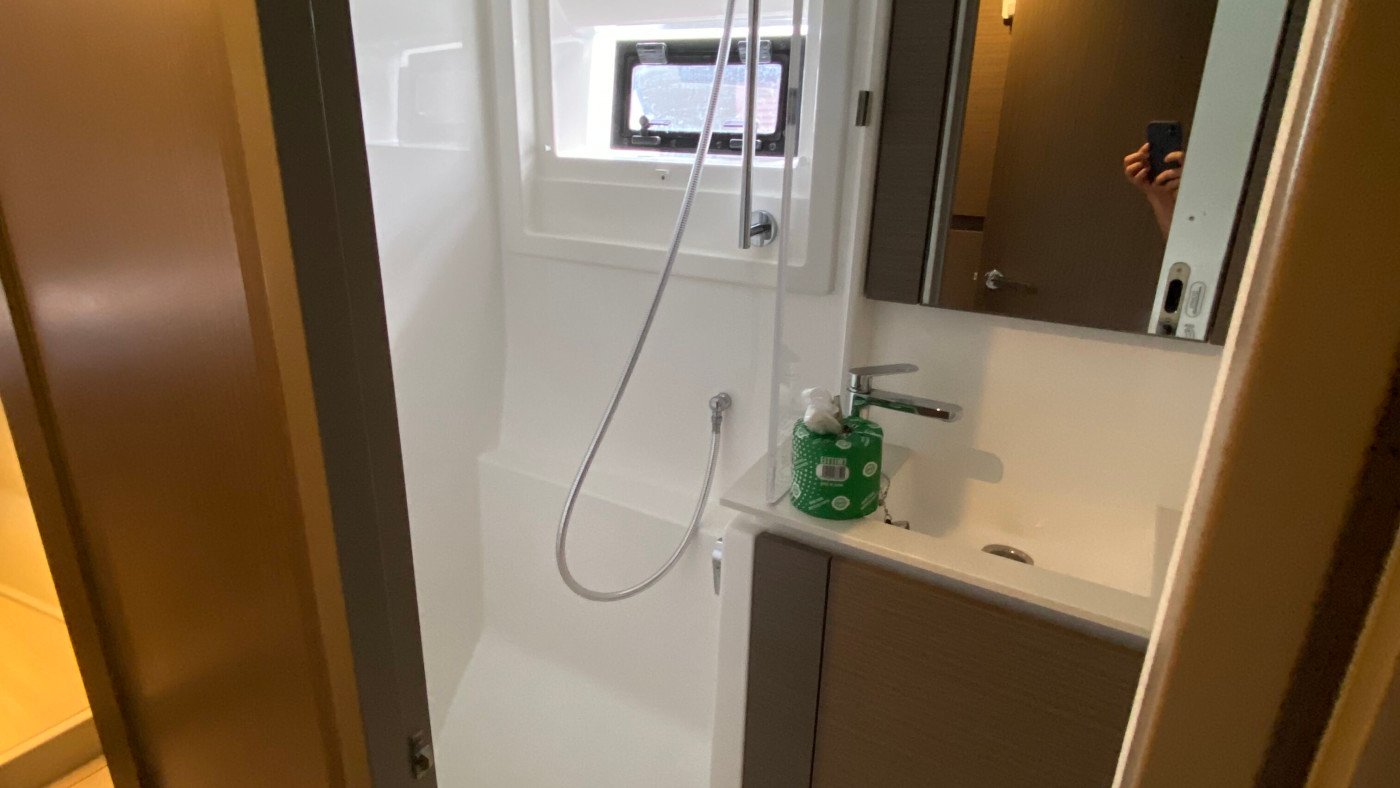 En-suite head aboard a Leopard 46 Powercat charter yacht with a separate shower stall, opening port and vanity