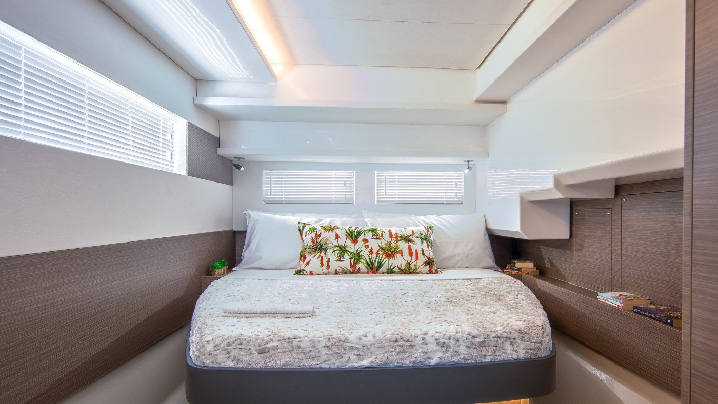 Guest cabin aboard a Leopard 46 Powercat charter yacht with a full double berth and twin hull-side windows