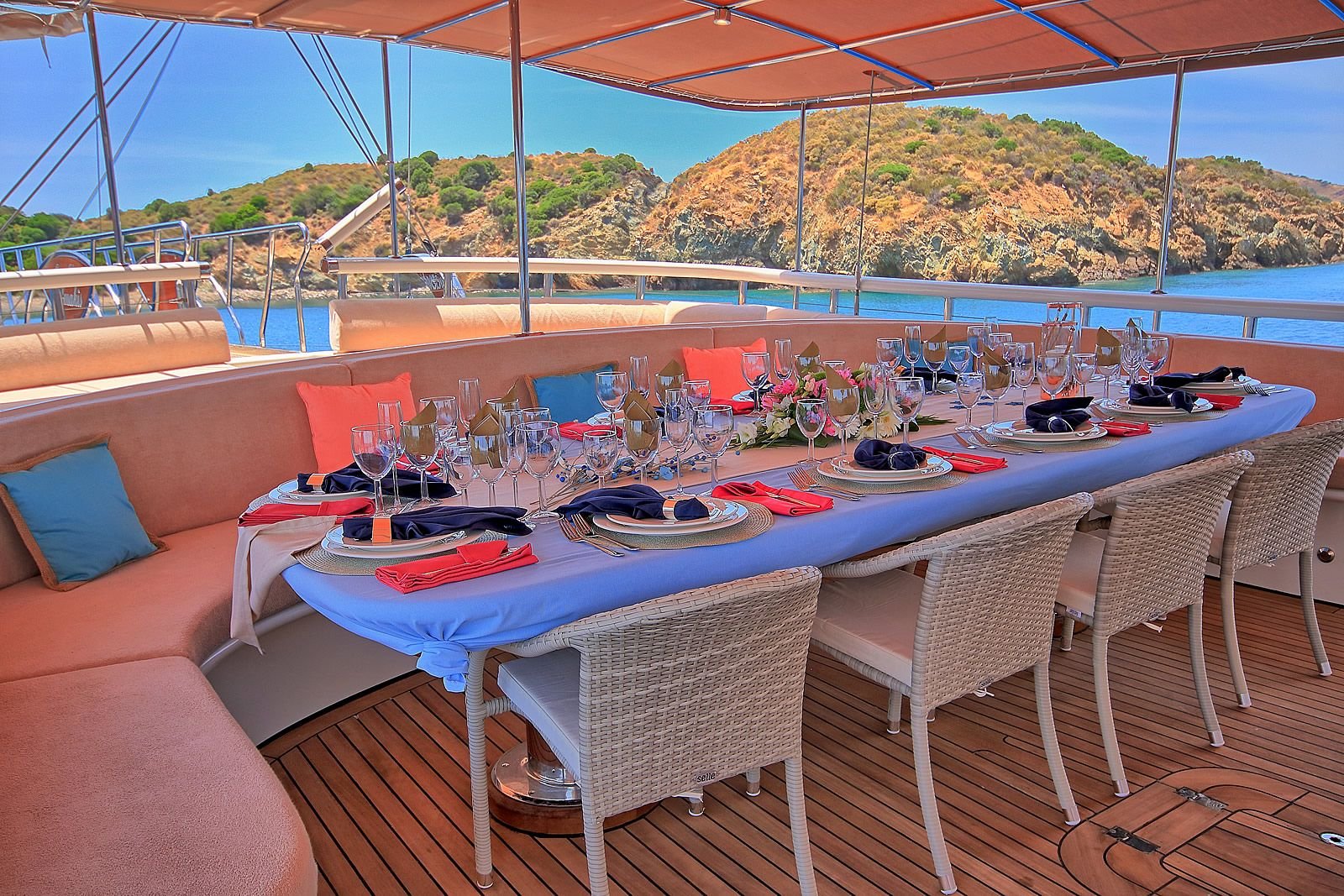 Aft deck dining table laid for eighteen aboard a luxury gulet charter in Bodrum