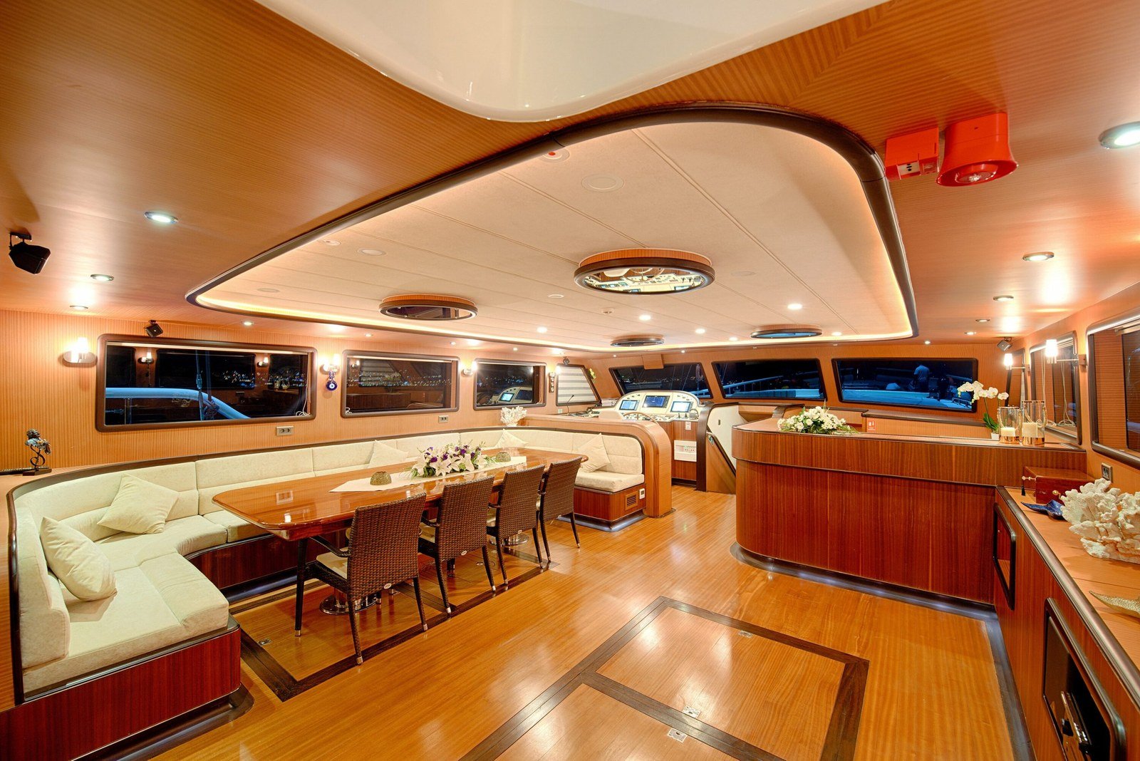 Main saloon with dining table and lounge aboard a 39m luxury gulet in Bodrum