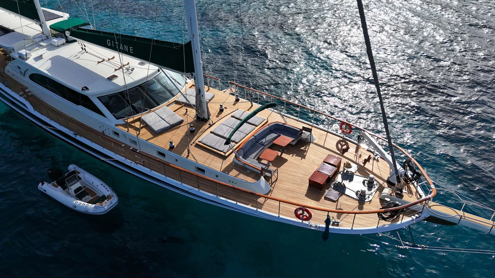 37m luxury motor sailer charter Bodrum underway with tender astern