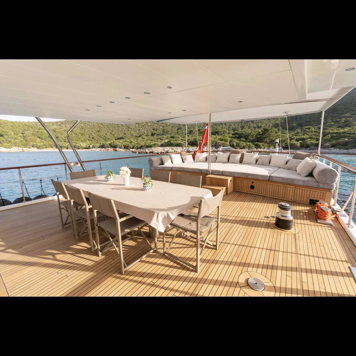 Aft deck dining table set for guests on a luxury motor sailer charter Bodrum yacht