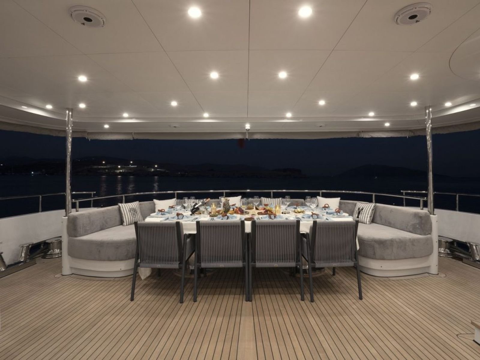 Aft deck dining laid at dusk aboard a luxury motor yacht charter in Turkey