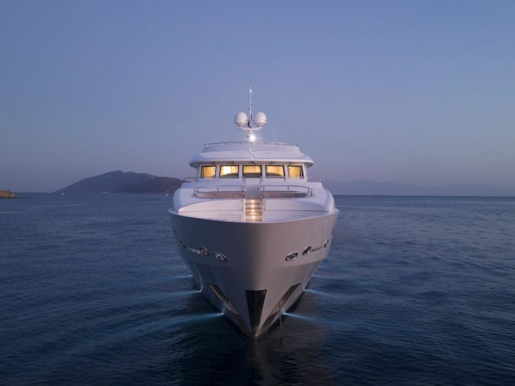 Luxury motor yacht charter Turkey - 42m motor yacht bow-on at dusk off Bodrum