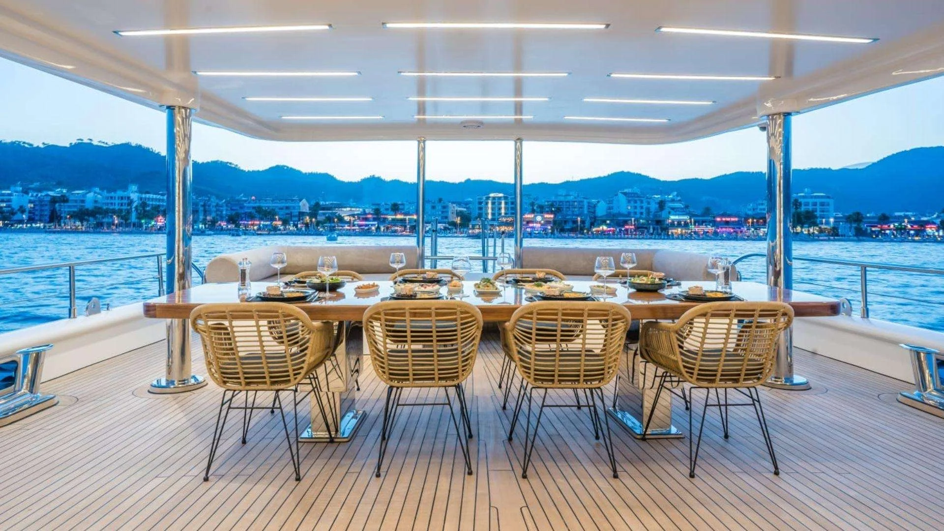 Aft deck dining table set for twelve on a luxury yacht charter Marmaris motor yacht at dusk