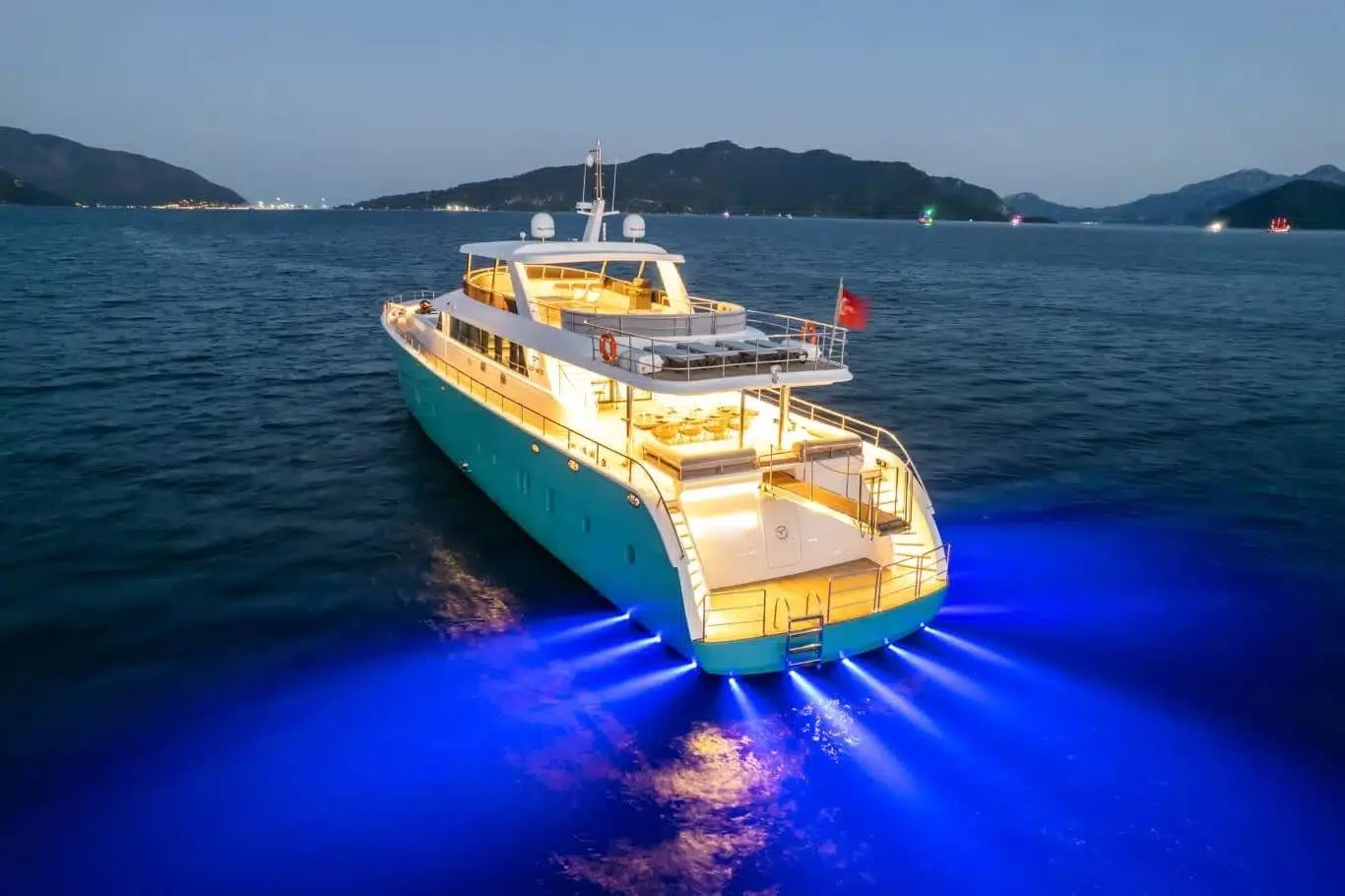 Night view with underwater lights of a luxury yacht charter Marmaris motor yacht off Marmaris