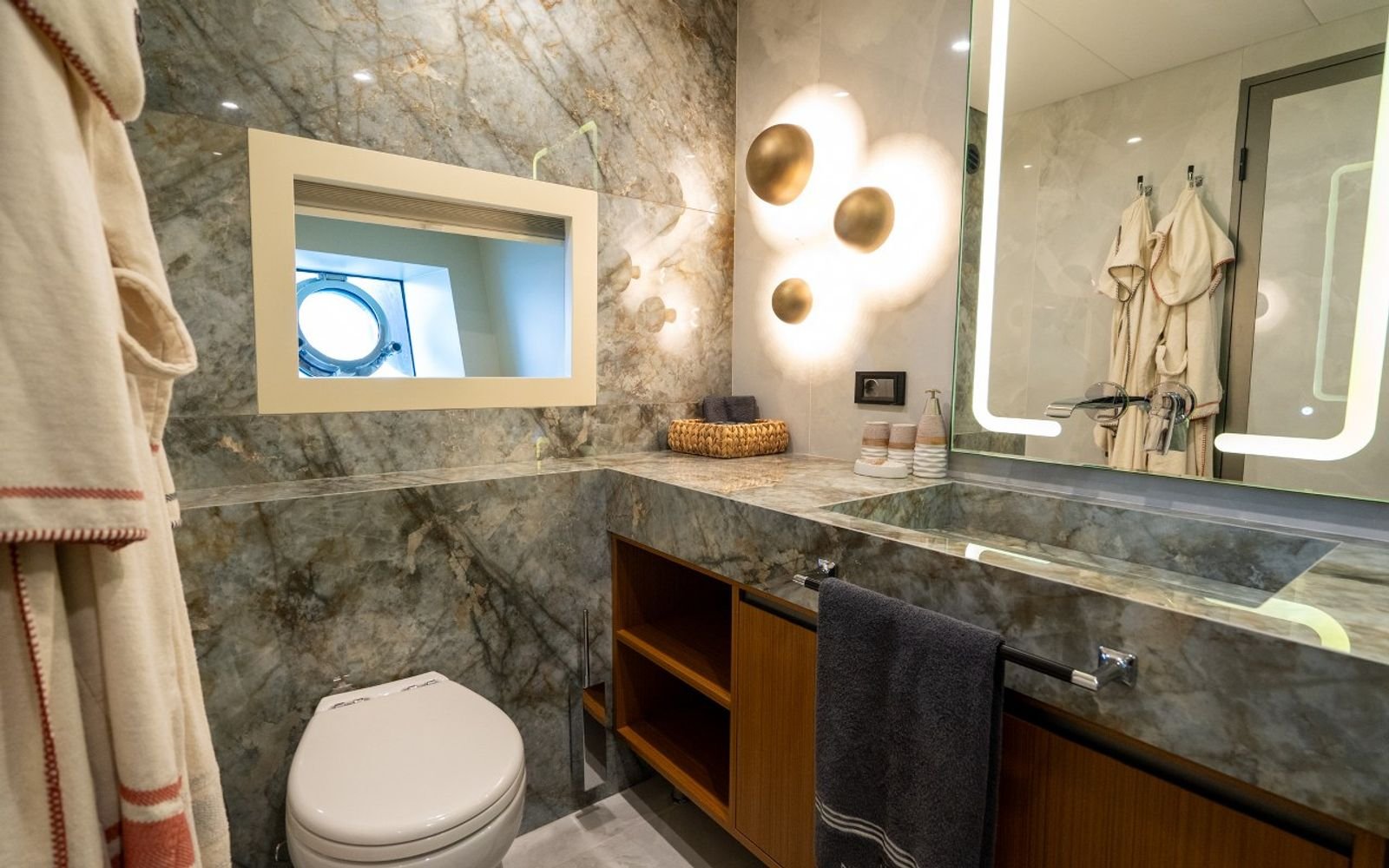 Marble en-suite bathroom with twin basins aboard a luxury sailing yacht charter
