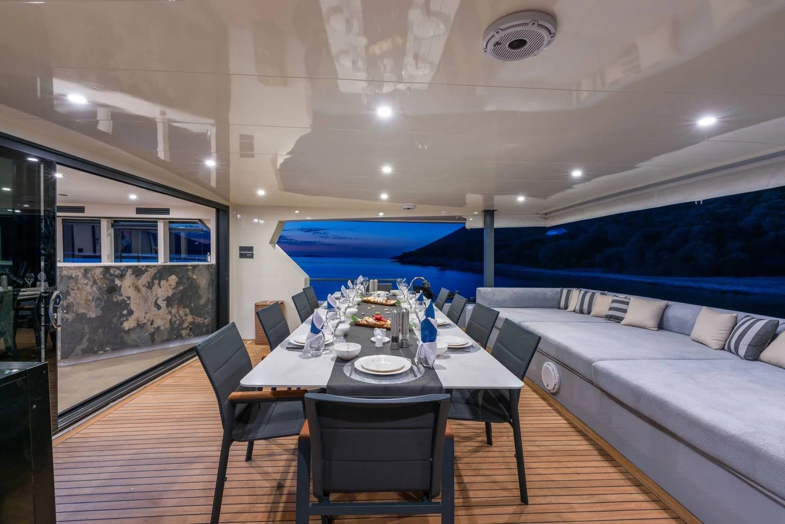 CD3023 30m luxury motor yacht charter Bodrum covered aft deck alfresco dining table at dusk