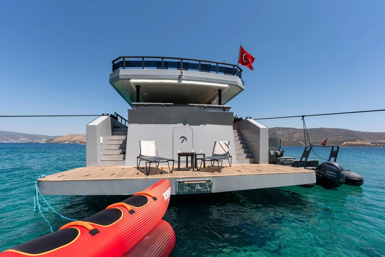 Crewed motor yacht charter Bodrum — CD3023 30m yacht anchored with kayak and water toys