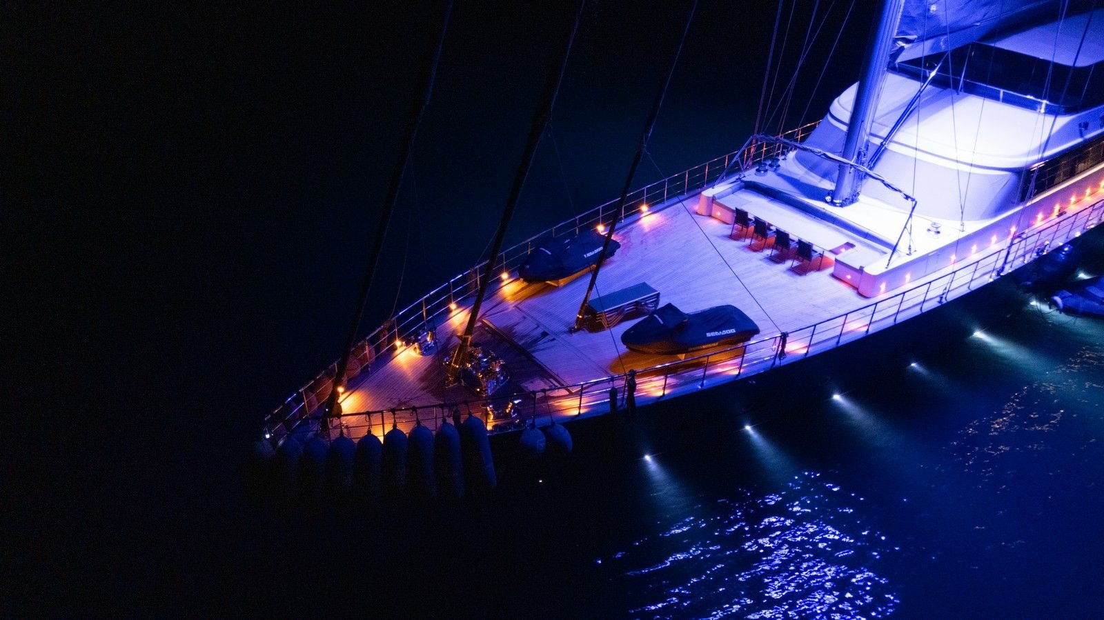 Night aerial of jet skis and tenders on the foredeck of a 47m luxury sailing yacht charter