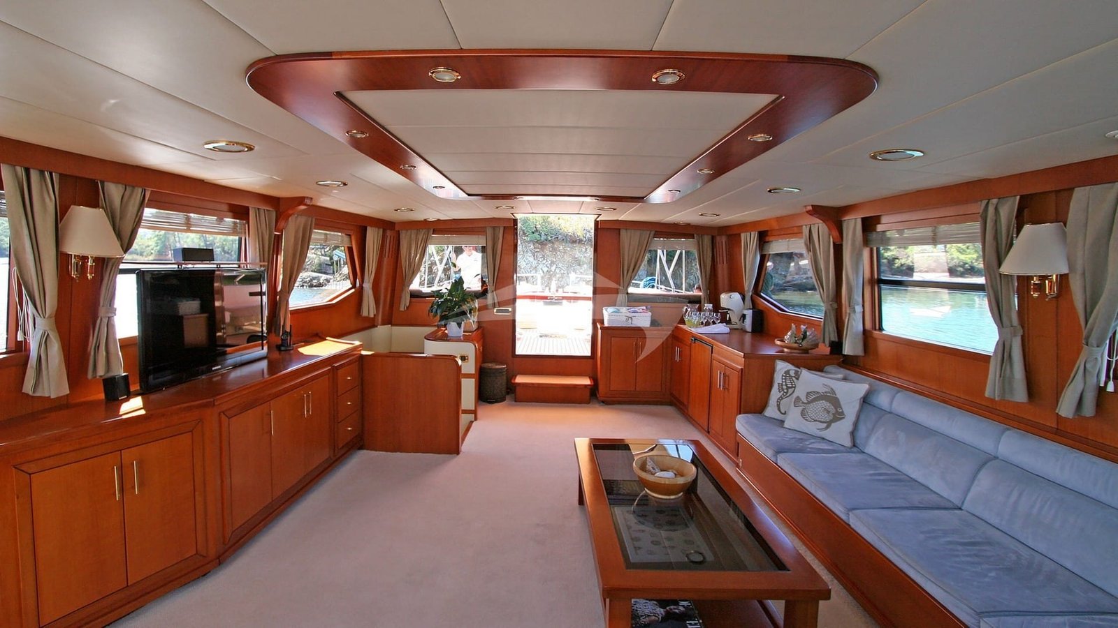 Main saloon with cherry joinery aboard a 26m crewed sailing yacht in Turkey