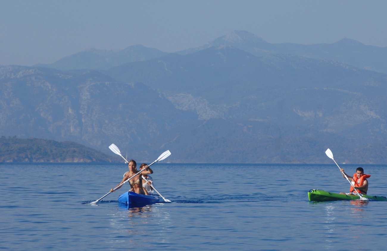 Guests sea kayaking from a crewed 43m motor sailer charter on the Turkish Riviera — MN4308