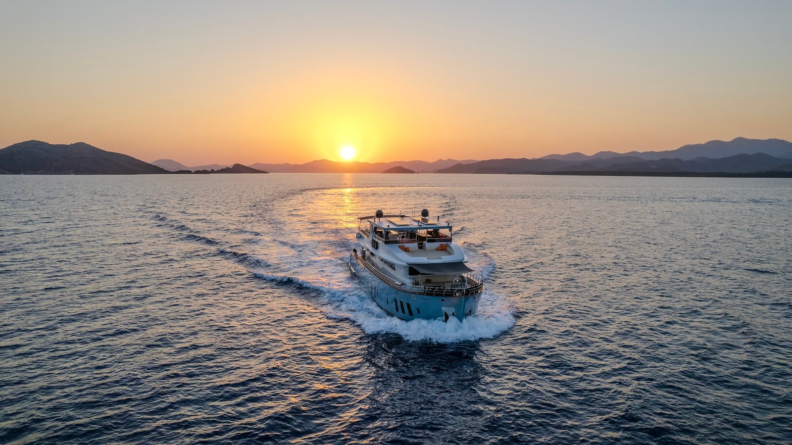Luxury trawler charter Fethiye SF2615 cruising at sunset off the Turkish coast