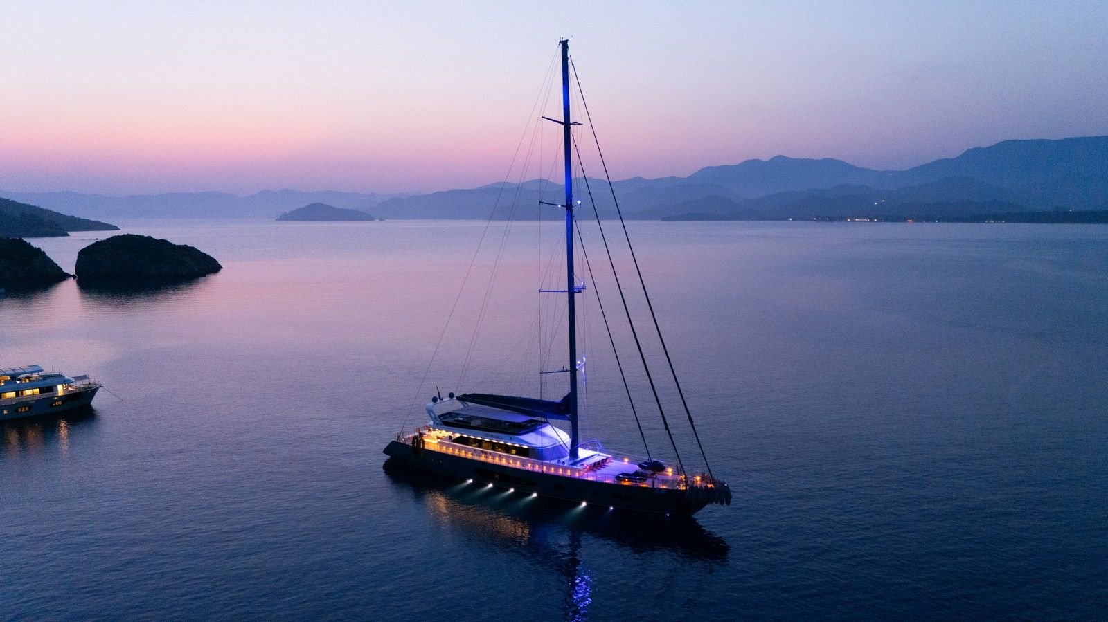 Sunset anchorage with underwater lights on a luxury sailing yacht charter in Turkey
