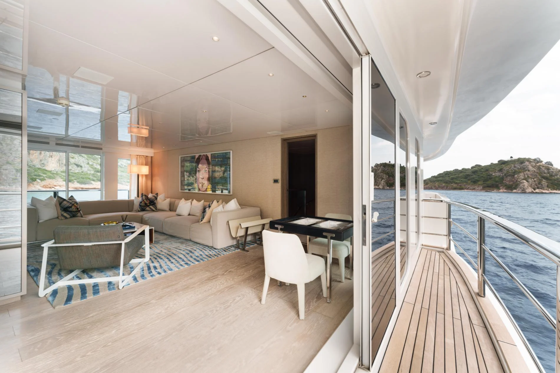 Main saloon opening to the side deck aboard a 47m superyacht charter — OS4712