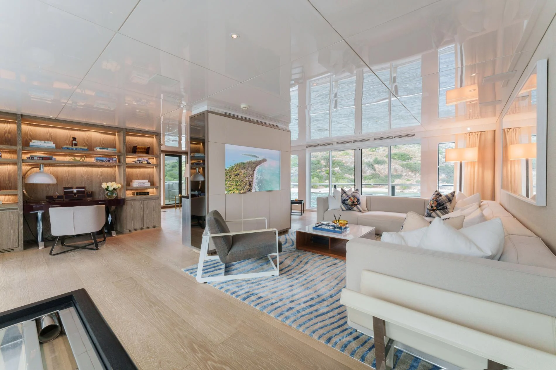 Upper saloon lounge and library aboard a 47m luxury superyacht charter — OS4712