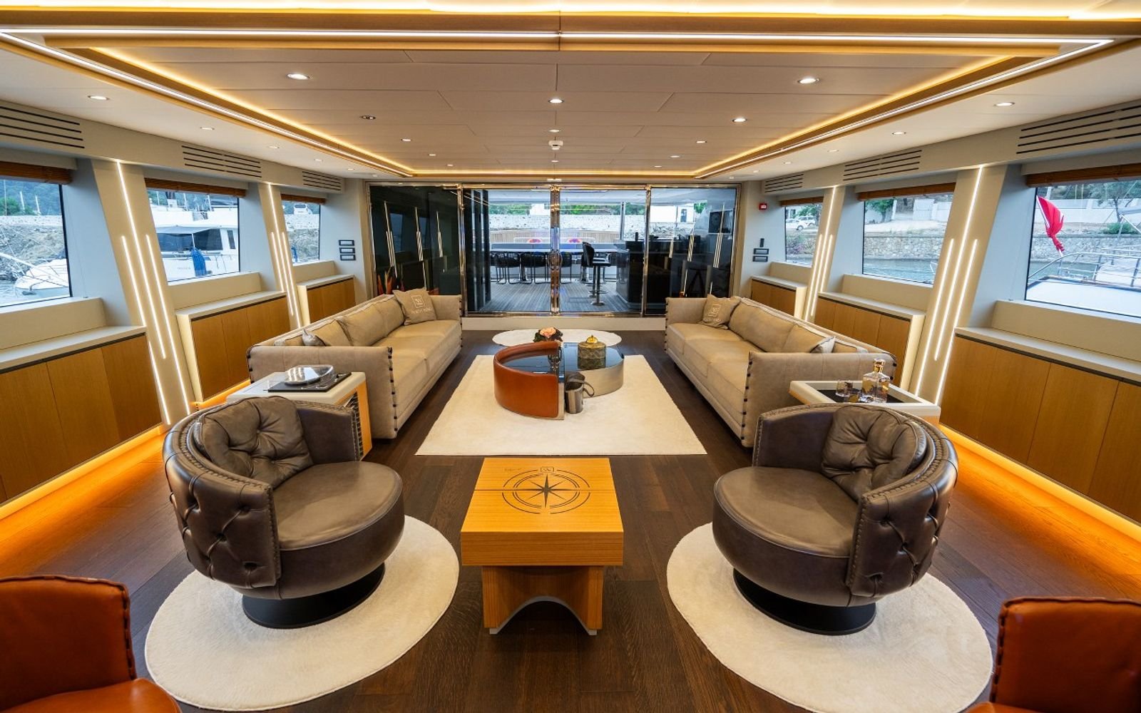 Upper saloon and sky lounge with swivel armchairs on a 47m luxury sailing yacht charter