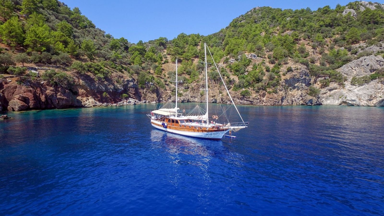 A gulet charter Marmaris vessel at anchor in a deep blue Aegean bay