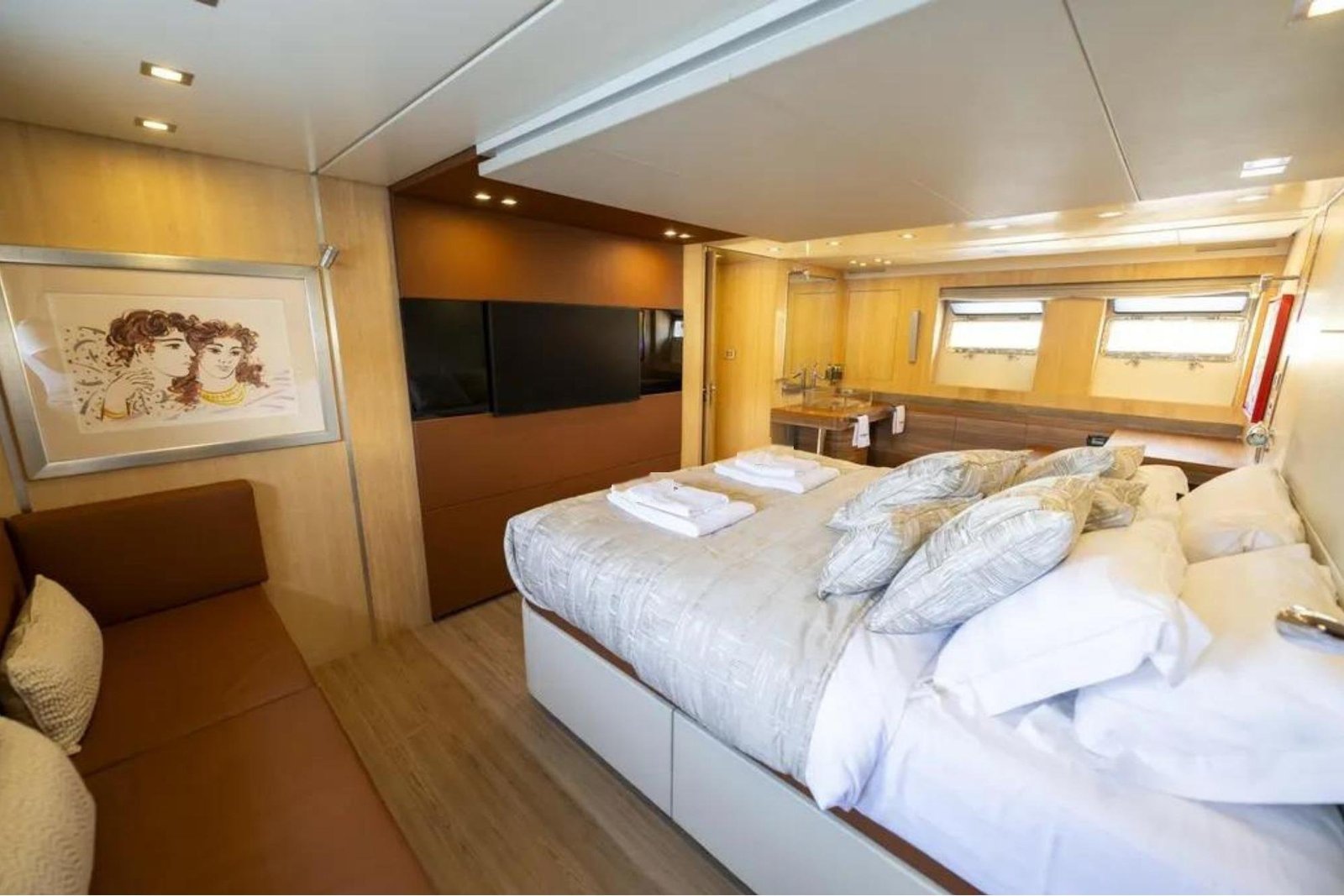 Full-beam master stateroom with lounge seating aboard an AB Yachts 92 charter Göcek